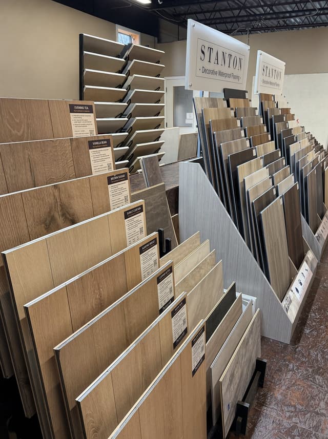 A second aisle of sample boards in the appointment-only hardwood, engineered and luxury vinyl showroom at All Dimensions Flooring in Lenexa